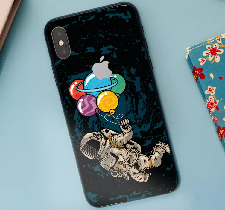 Astronaut in space with balloons iPhone sticker - TenStickers
